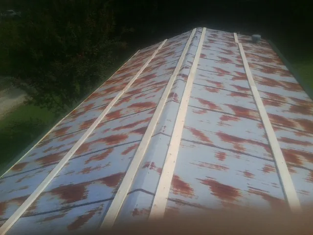 Rusted metal roof panels with new wood purlins before replacement — Storm Damage Roof Repair in Abbeville by Roofing Brothers