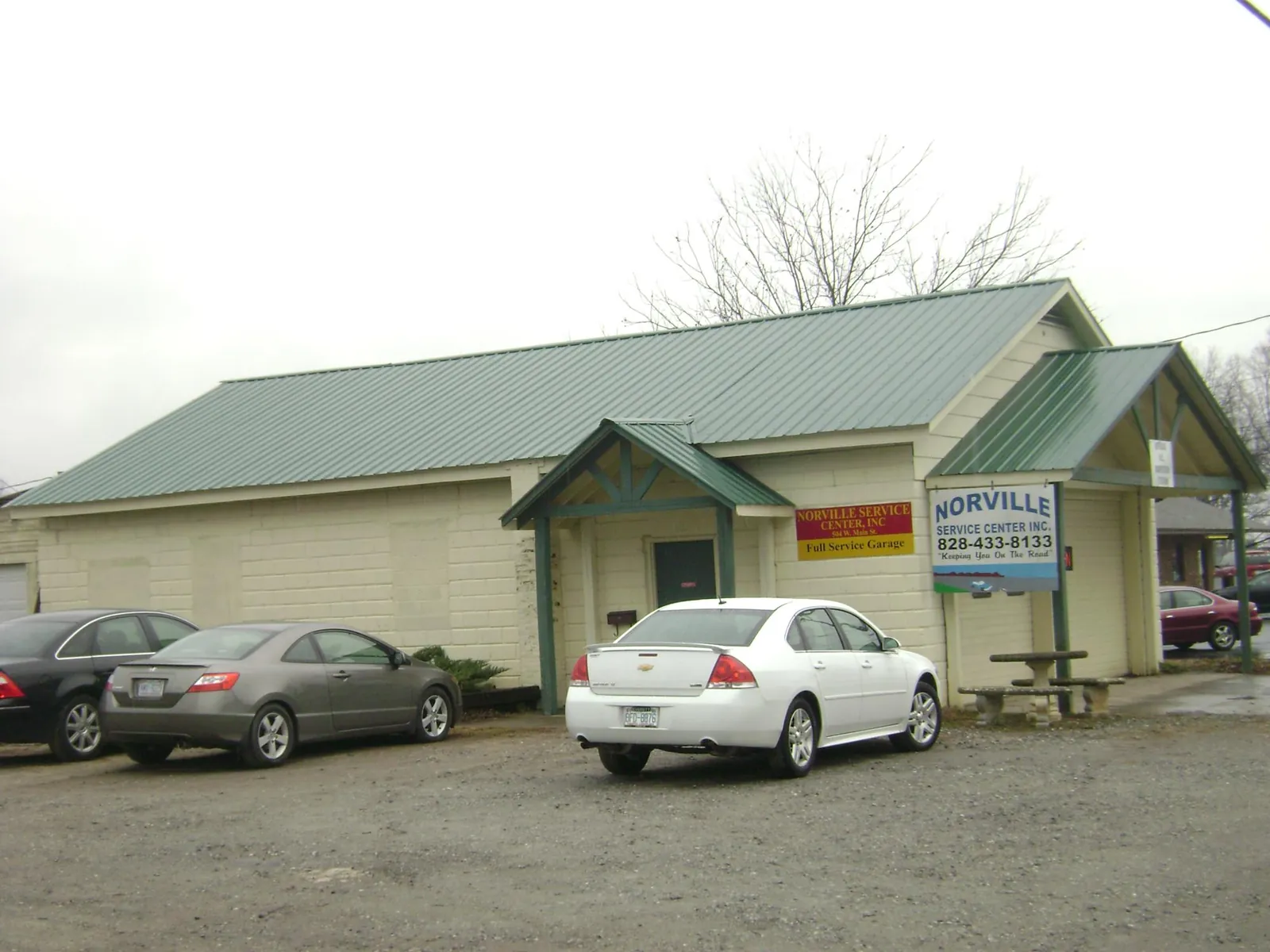 Green metal roof on a service garage with a covered entry in Abbeville